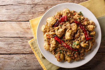 Indian food: Chettinad chicken curry with chili pepper closeup. horizontal top view