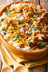 Asian biryani with chicken, spices and herbs close-up. vertical