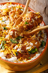 Spicy hot chicken dum biryani close-up in dish on table. vertical