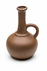 A small brown clay jug close-up on a white background.