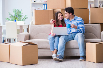 Young pair moving in to new house with boxes