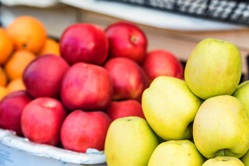 Piles of red and green apples on outdoor market