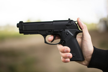 Killer with gun close up over grunge background with copyspace.