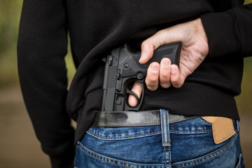 Man hid gun behind their back, robbery, crime, kidnapping