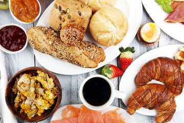 breakfast on table with waffles, croissants, coffe and juice