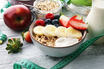 muesli with dairy and fruit, healthy lifestyle. bowl of cereal, fruit and dumbbell