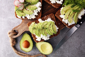sliced avocado on toast bread with spices © beats_