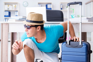 Businessman preparing for vacation in the office