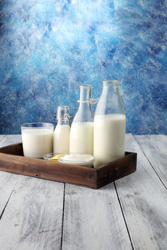 milk products. tasty healthy dairy products on a table on. sour cream in a bowl, cottage cheese bowl, cream in a a bank and milk jar, glass bottle and in a glass