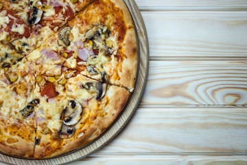 Pizza served on wooden table