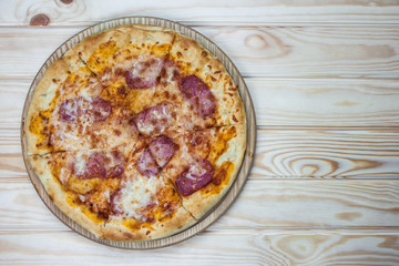 Pizza served on wooden table