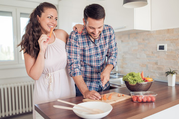 Young couple having fun from preparing food together
