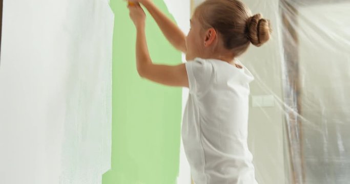 Girl painting wall to white