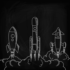Space rockets, after the launch, soared up. Drawing chalk on a blackboard.