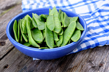 blue bowl with green peapods
