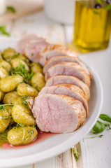 Pork tenderloin with herbs and spices, pesto gnocchi