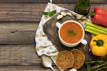 Thick Italian soup minestrone on a wooden table