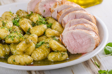 Pork tenderloin with herbs and spices, pesto gnocchi