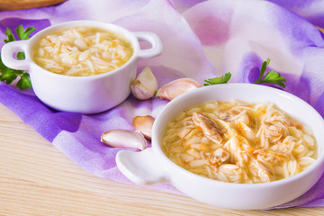 noodle soup and chicken with carrot and garlic