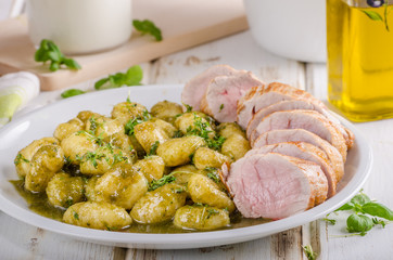 Pork tenderloin with herbs and spices, pesto gnocchi