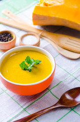 Pumpkin soup served on the table in bowl