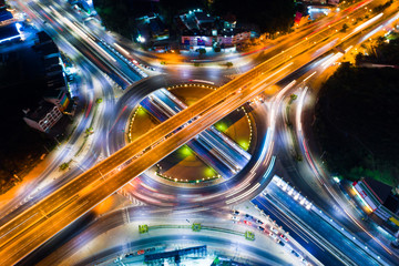 Roundabout intersection city road at night with vehicle light movement