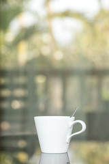 Close up A cup of coffee with outdoor background
