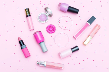 Pink make-up cosmetics on a pink background. Flat lay