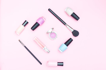 Female beauty makeup on pink background. Flat lay
