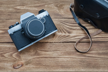 Vintage camera on textured boards.