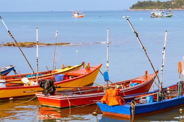 colorful fishing boats in a roll foreground with blue sea at Koh-Lan Pattaya Thailand