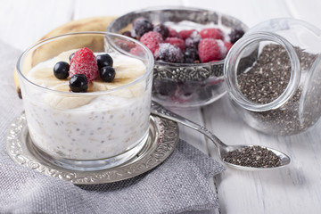 Smoothies with chia seeds and oat flakes with banana and frozen blueberries and raspberries