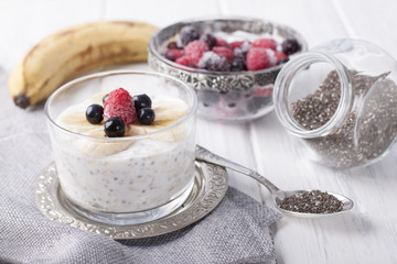 Smoothies with chia seeds and oat flakes with banana and frozen blueberries and raspberries
