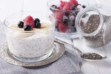 Smoothies with chia seeds and oat flakes with banana and frozen blueberries and raspberries