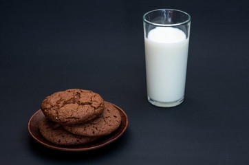 Composition with biscuits and milk. Cow milk in a glass.