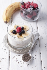 Smoothies with chia seeds and oat flakes with banana and frozen blueberries and raspberries