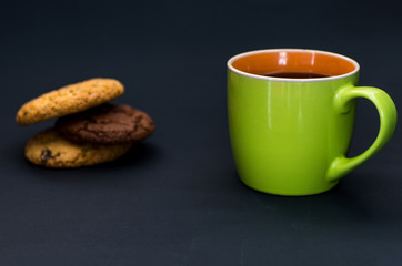 Green orange mug and homemade cookies.