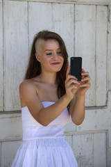 Fototapeta premium preety young girl taking a photo with a phone