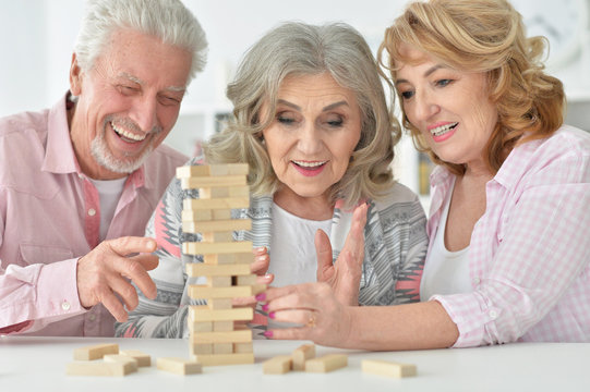 senior people playing with wooden blocks