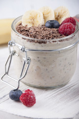 Smoothies with chia seeds, oatmeal, banana and berries of blueberries, raspberries and grated chocolate