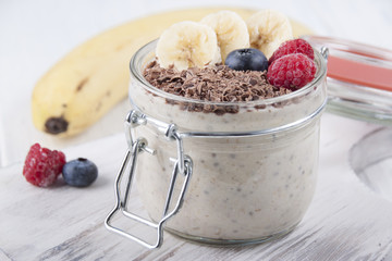 Smoothies with chia seeds, oatmeal, banana and berries of blueberries, raspberries and grated chocolate