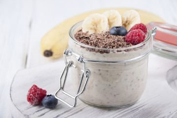 Smoothies with chia seeds, oatmeal, banana and berries of blueberries, raspberries and grated chocolate