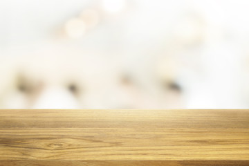 Beautiful empty wooden table and white modern kitchen cafe background