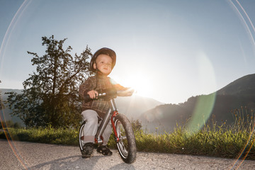 Boy is riding with balance bike