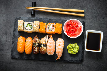 Sushi and sushi roll set on black stone table top view © nadianb