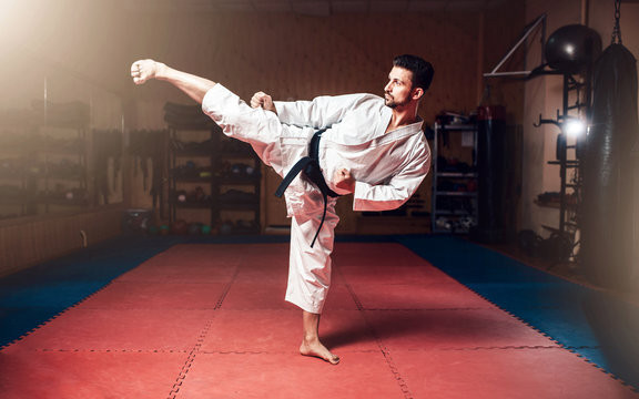 Martial arts, man in white kimono with black belt