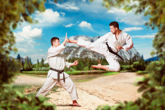 Martial arts, kick in jump, outdoors practice