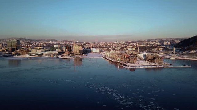 Aerial crane shot of Lambda Munch museum, Opera and houses in Sorenga in Oslo, Norway in winter