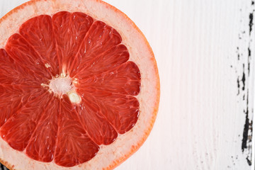 Grapefruit on white wooden background