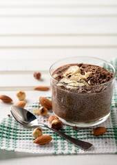 chia pudding with chocolate banana smoothie in a glass jar on the old wooden background